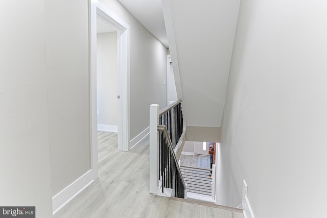 stairway featuring baseboards and wood finished floors