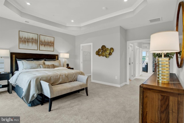 bedroom with visible vents, baseboards, a tray ceiling, light carpet, and recessed lighting