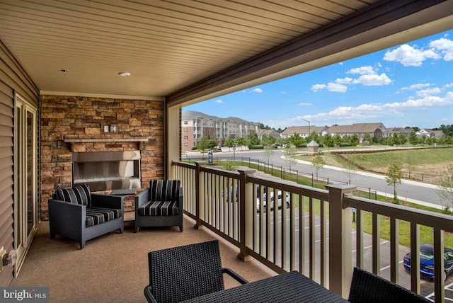 balcony featuring a residential view and a fireplace