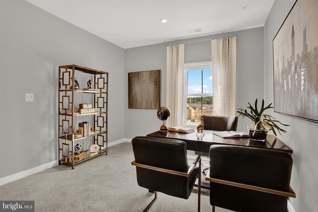 carpeted office featuring visible vents and baseboards