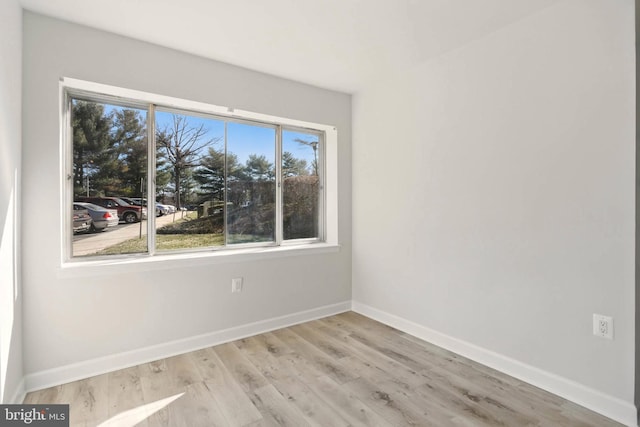 empty room featuring baseboards and wood finished floors