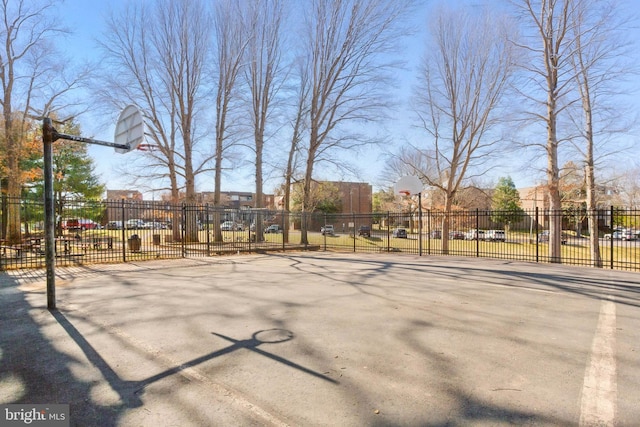 exterior space featuring community basketball court and fence