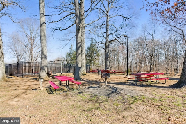 view of home's community with fence