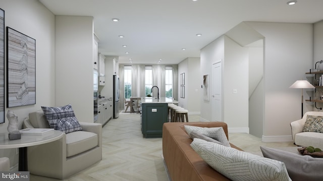 living area with recessed lighting and baseboards