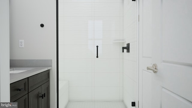 bathroom with a stall shower and vanity