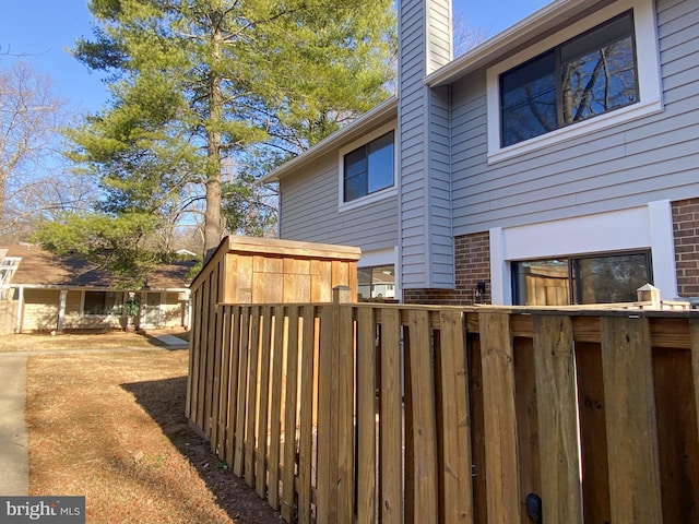 view of home's exterior featuring brick siding and a chimney