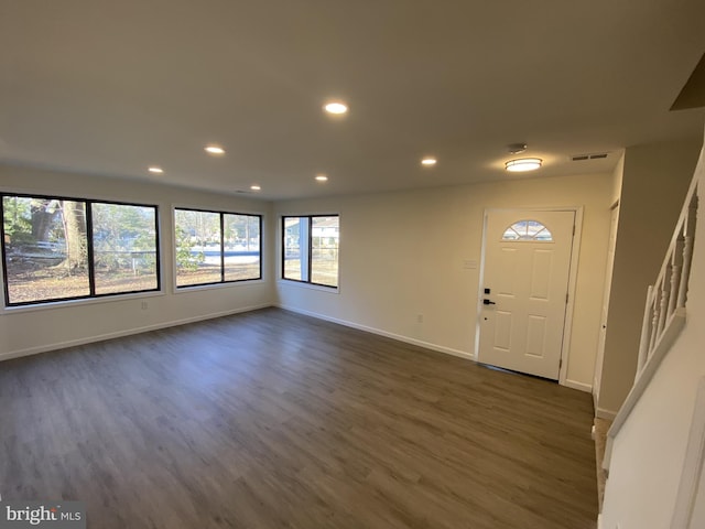 foyer with recessed lighting, visible vents, baseboards, and dark wood-type flooring