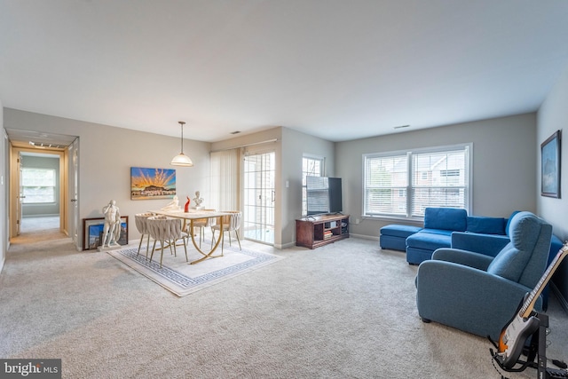 carpeted living room with baseboards