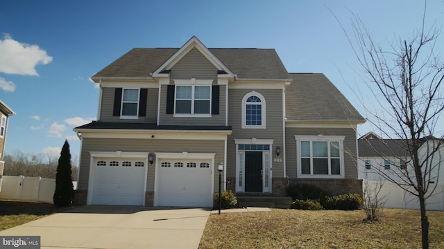 craftsman house featuring an attached garage, driveway, and fence