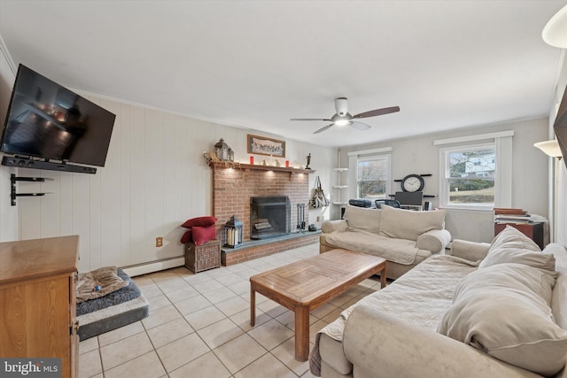 living room with ceiling fan, a baseboard heating unit, a brick fireplace, and light tile patterned flooring