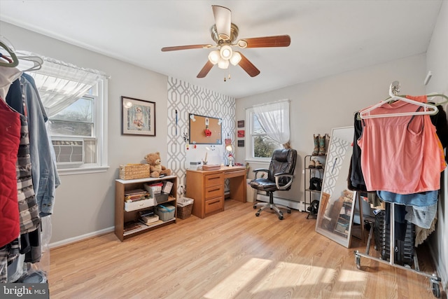 office space featuring a ceiling fan, baseboards, and wood finished floors