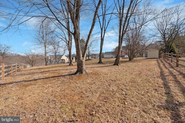 view of yard with an outdoor structure and fence