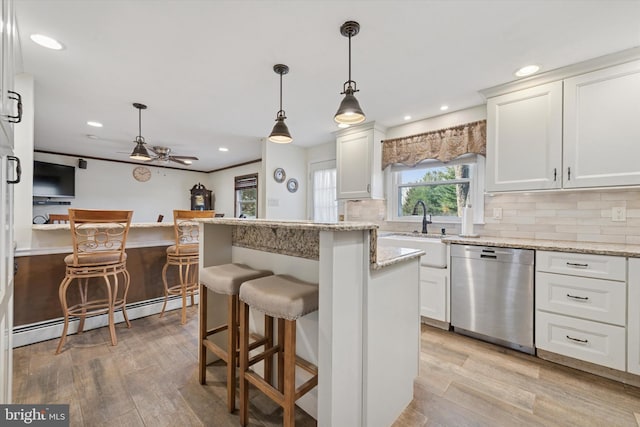 kitchen with a sink, a baseboard radiator, dishwasher, and light wood finished floors