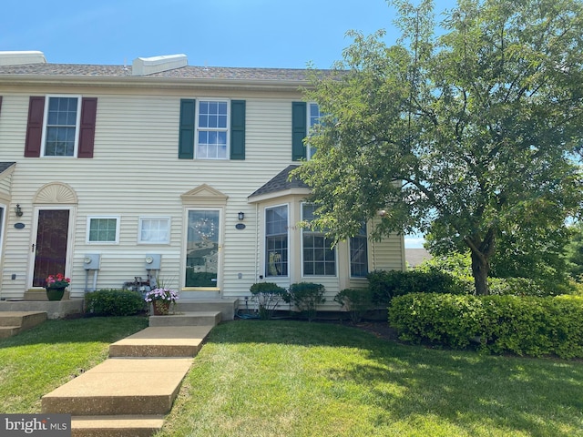 view of property featuring a front lawn