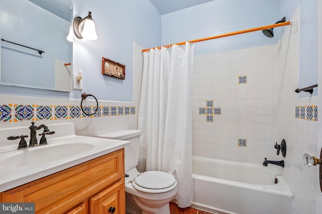 full bath with vanity, toilet, tile walls, and shower / tub combo