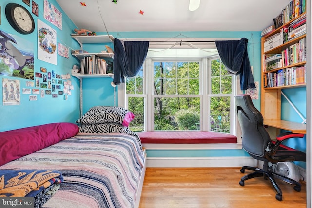 bedroom with baseboards and wood finished floors