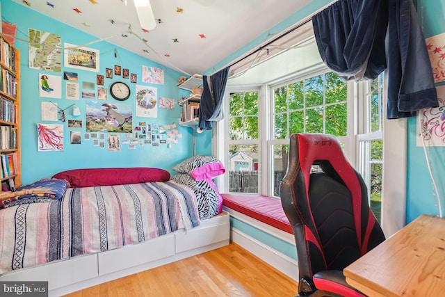 bedroom featuring vaulted ceiling and wood finished floors
