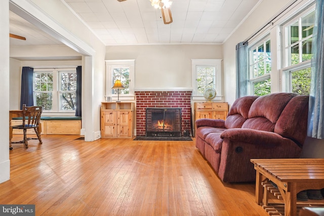 living room featuring ceiling fan, a wealth of natural light, and hardwood / wood-style flooring