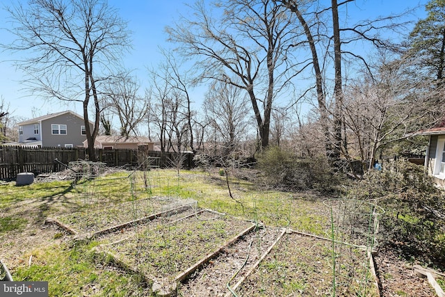 view of yard with a garden and fence