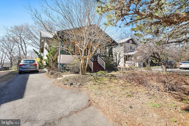 view of side of home with driveway