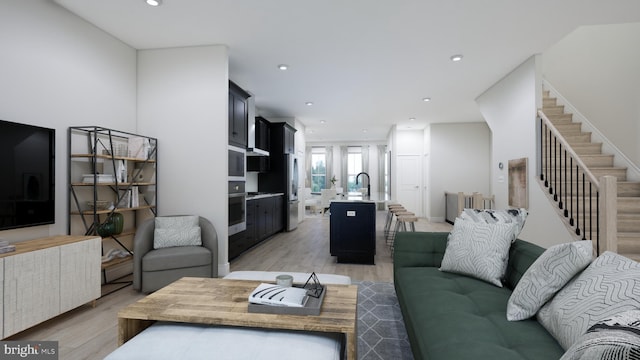 living area featuring stairway, recessed lighting, and light wood-type flooring