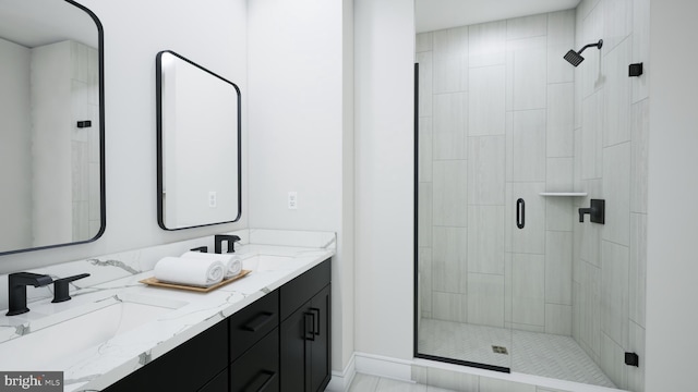 bathroom featuring a sink, double vanity, and a shower stall