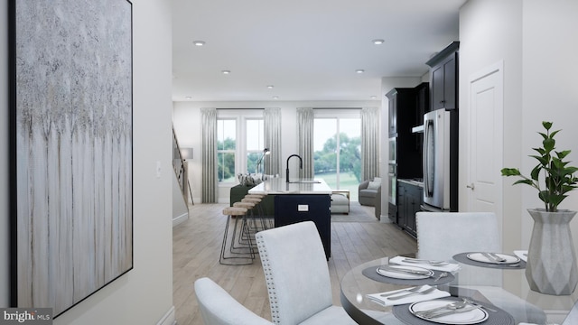 dining area featuring recessed lighting, baseboards, and light wood finished floors