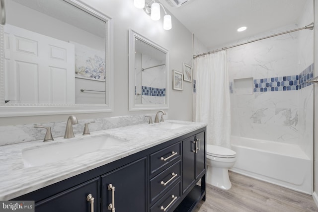 bathroom with a sink, shower / bathtub combination with curtain, toilet, and wood finished floors