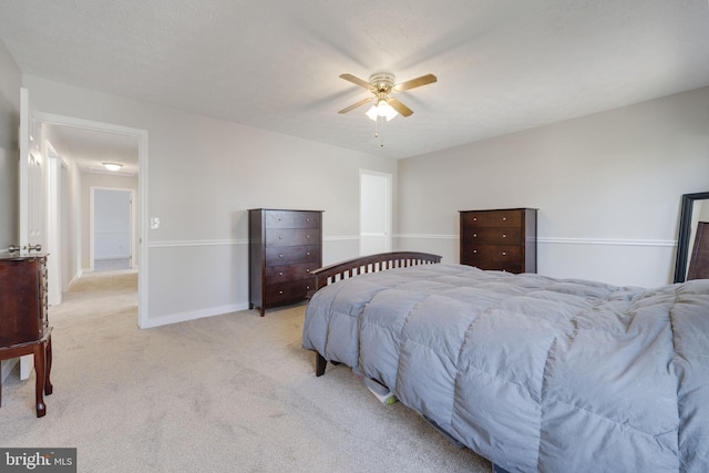 bedroom with baseboards, light carpet, and ceiling fan