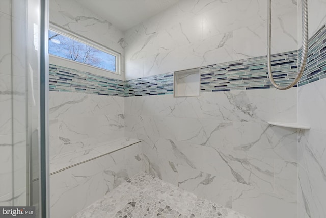 full bathroom with a marble finish shower