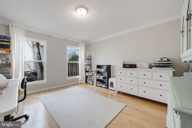 office area featuring crown molding, baseboards, light wood finished floors, and a textured ceiling