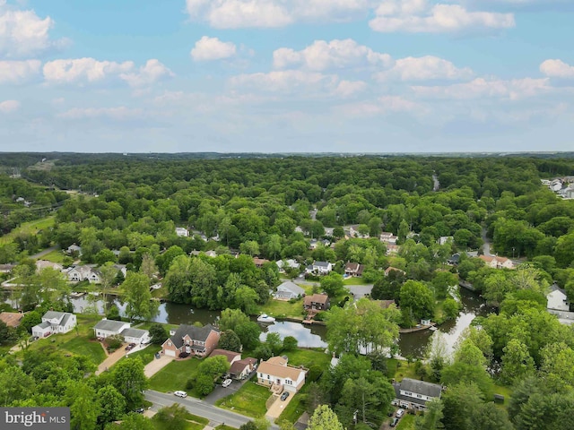 drone / aerial view with a residential view, a forest view, and a water view