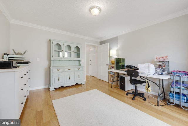 office with crown molding, light wood-style flooring, baseboards, and a textured ceiling