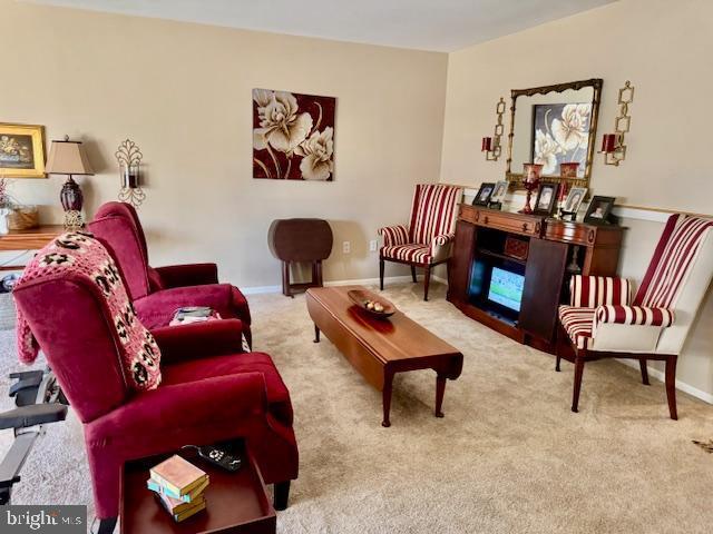 sitting room with carpet flooring and baseboards