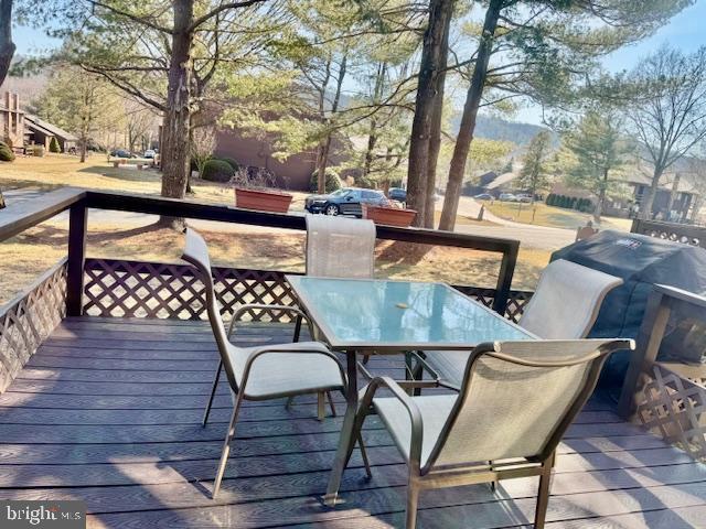 wooden deck with outdoor dining space