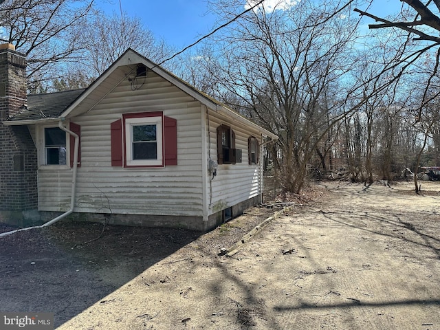 view of property exterior featuring a chimney