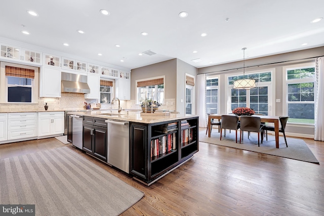 6813 Millwood Rd, Bethesda, MD 20817 - kitchen featuring dishwasher, a sink, wall chimney range hood, white cabinetry, and plenty of natural light