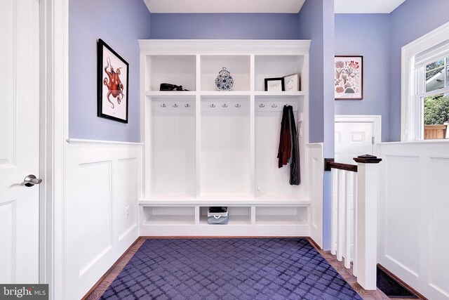 6813 Millwood Rd, Bethesda, MD 20817 - mudroom with a wainscoted wall, dark wood-style floors, and a decorative wall
