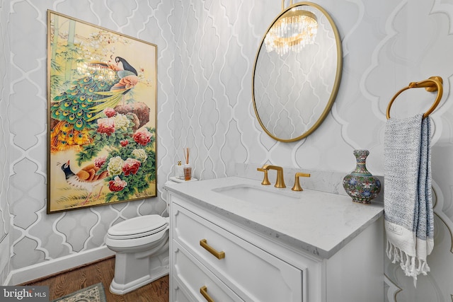 6813 Millwood Rd, Bethesda, MD 20817 - bathroom featuring wallpapered walls, wood finished floors, vanity, toilet, and a chandelier