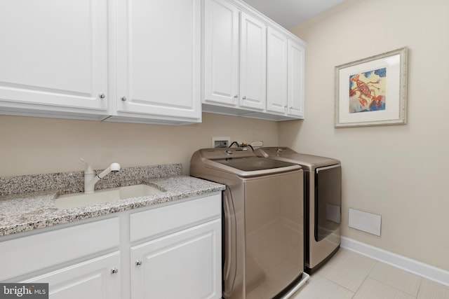 6813 Millwood Rd, Bethesda, MD 20817 - clothes washing area featuring cabinet space, washer and clothes dryer, baseboards, and light tile patterned floors