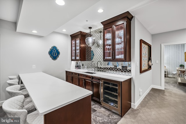 6813 Millwood Rd, Bethesda, MD 20817 - indoor wet bar with wine cooler, recessed lighting, decorative backsplash, pendant lighting, and baseboards