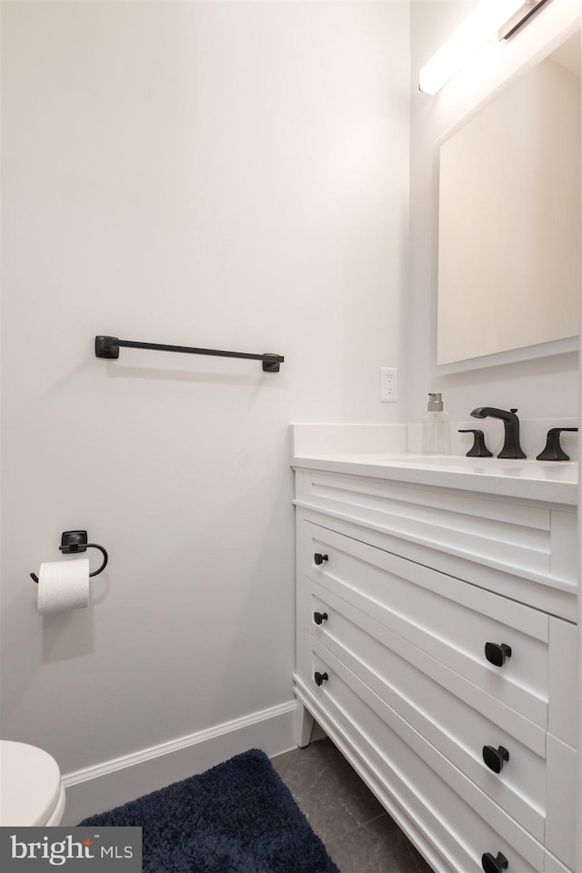 6813 Millwood Rd, Bethesda, MD 20817 - bathroom featuring vanity, baseboards, and toilet