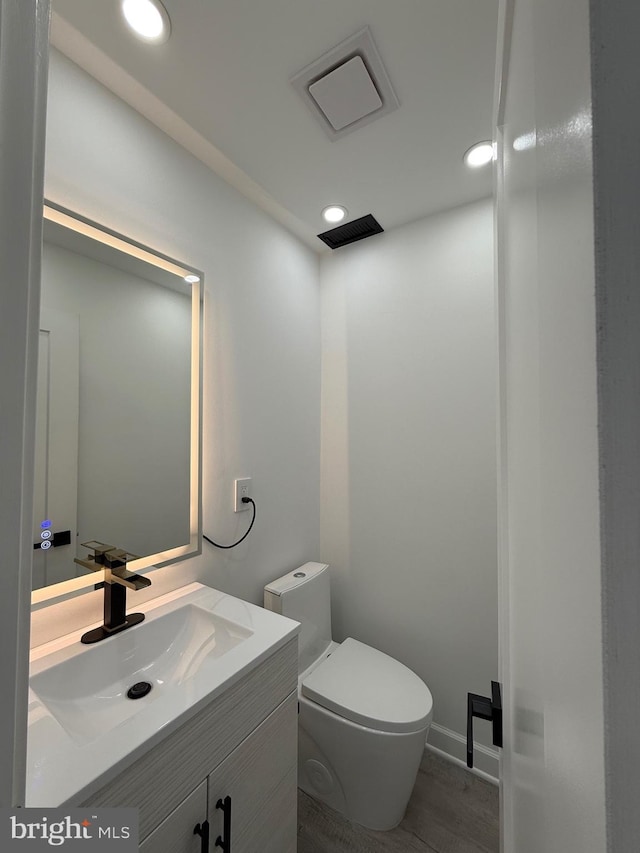 bathroom with vanity, toilet, recessed lighting, and visible vents