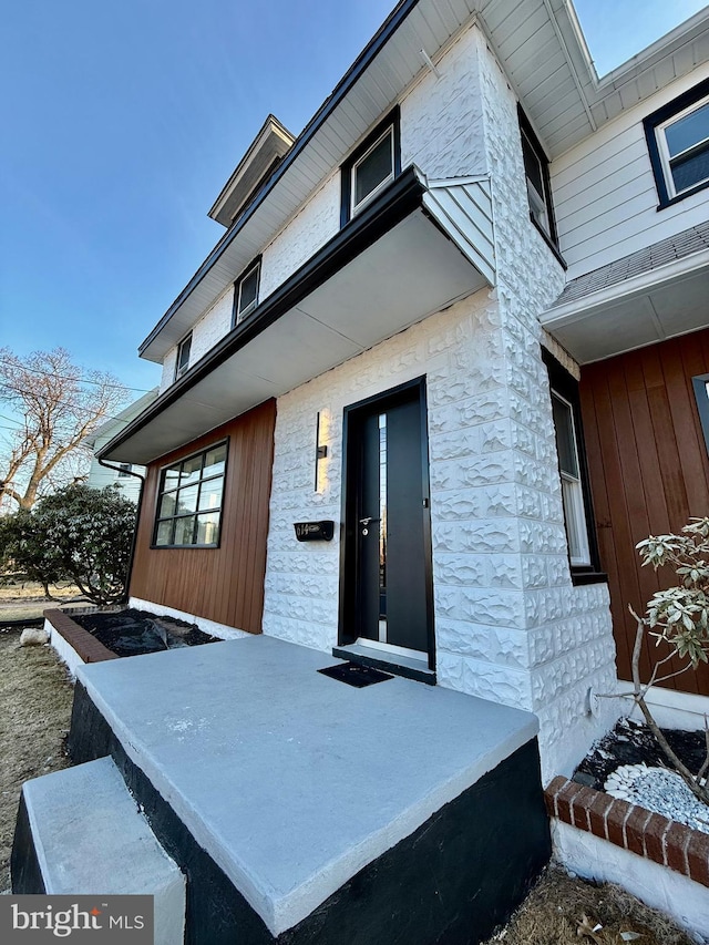 doorway to property featuring stone siding