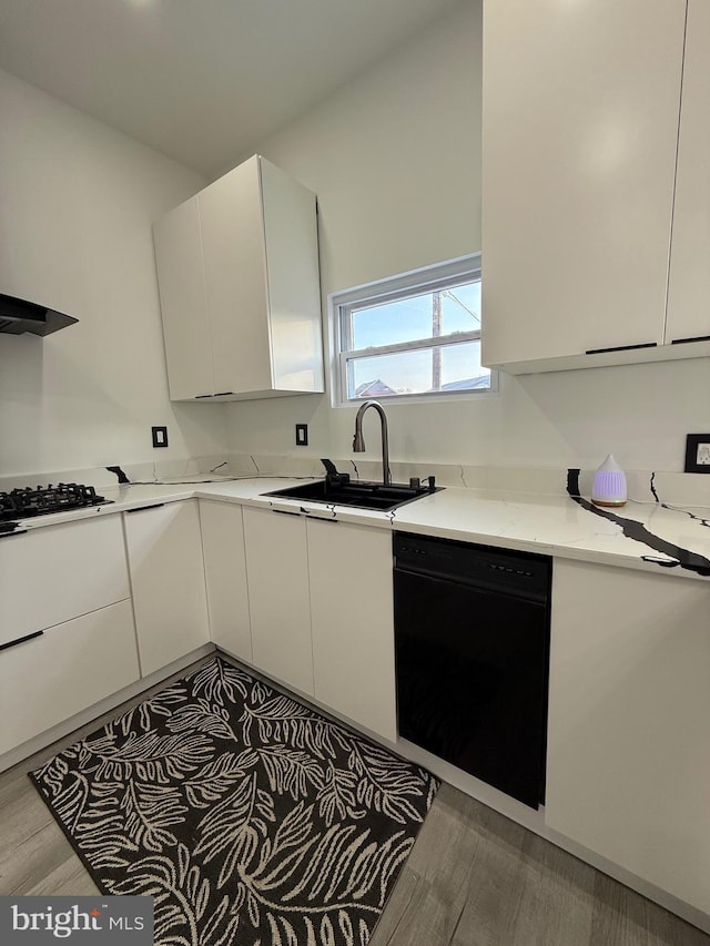 kitchen with a sink, white cabinetry, dishwasher, and gas stovetop