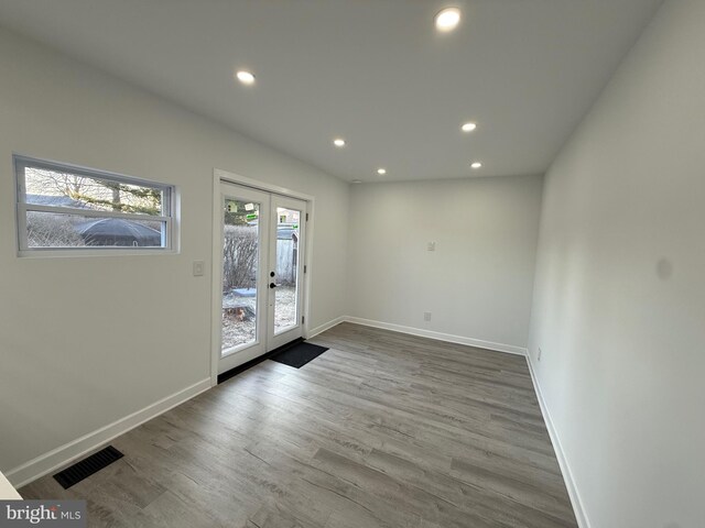 unfurnished room with visible vents, baseboards, recessed lighting, french doors, and wood finished floors