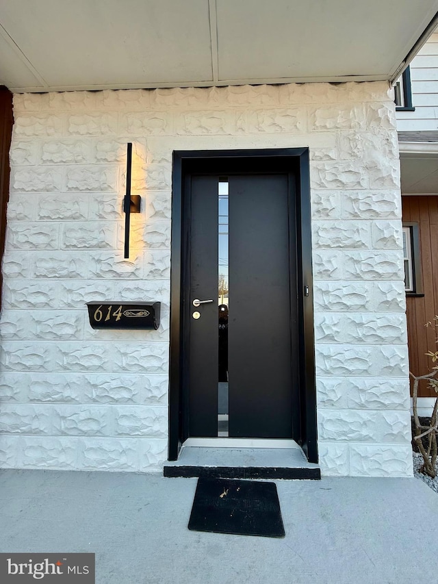 entrance to property with stone siding