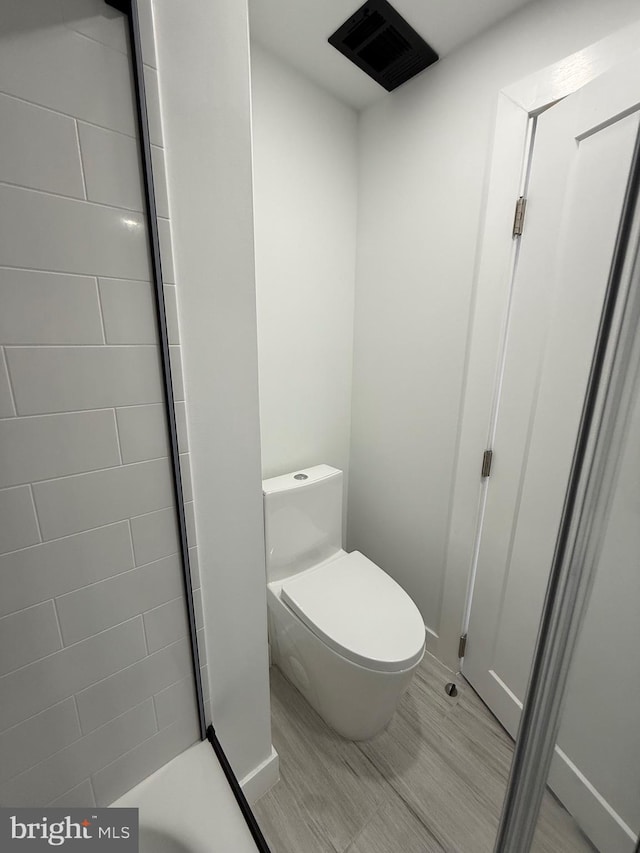 bathroom with visible vents and toilet