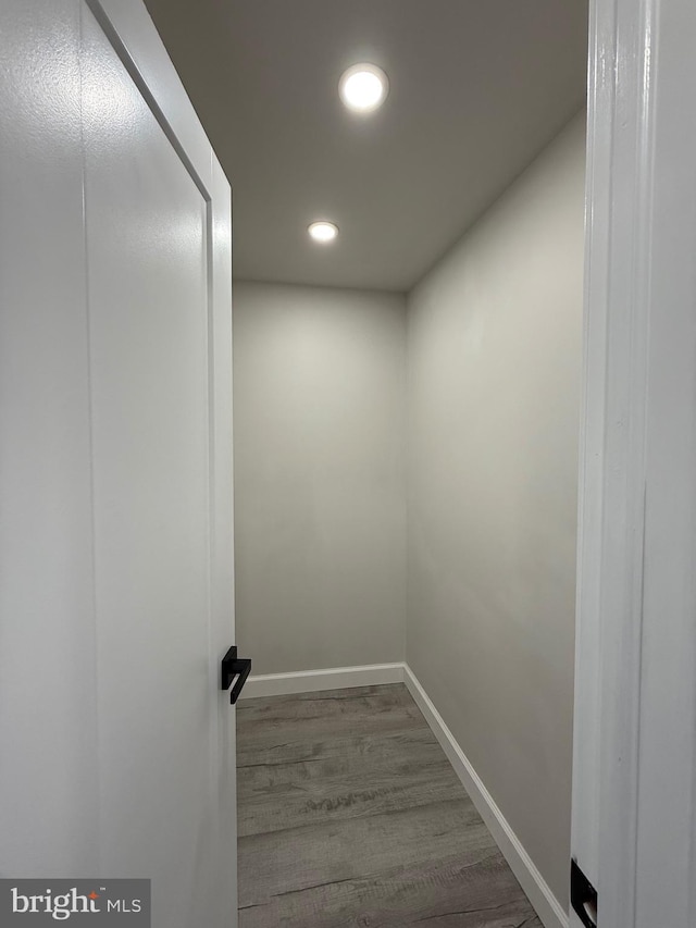 interior space featuring recessed lighting, baseboards, and wood finished floors