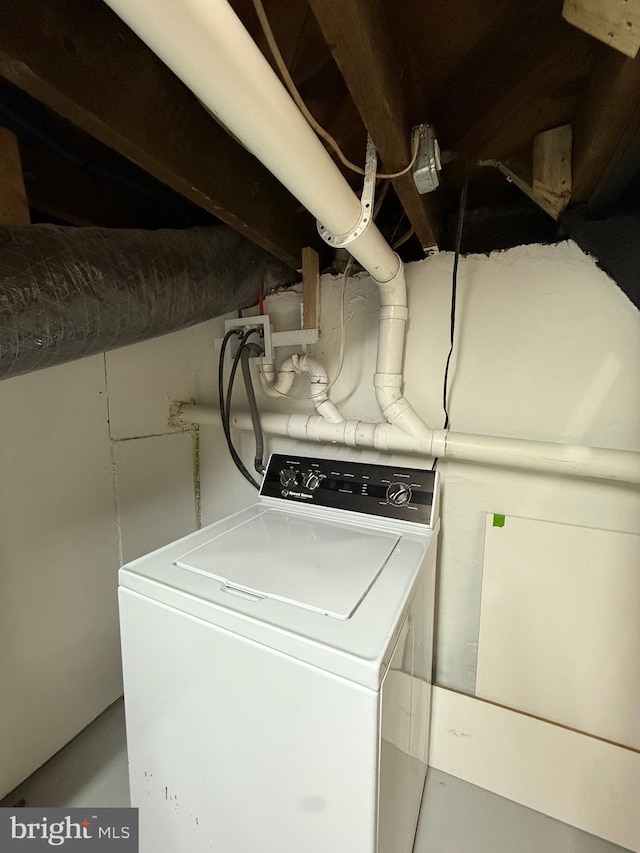 clothes washing area featuring laundry area and washer / clothes dryer